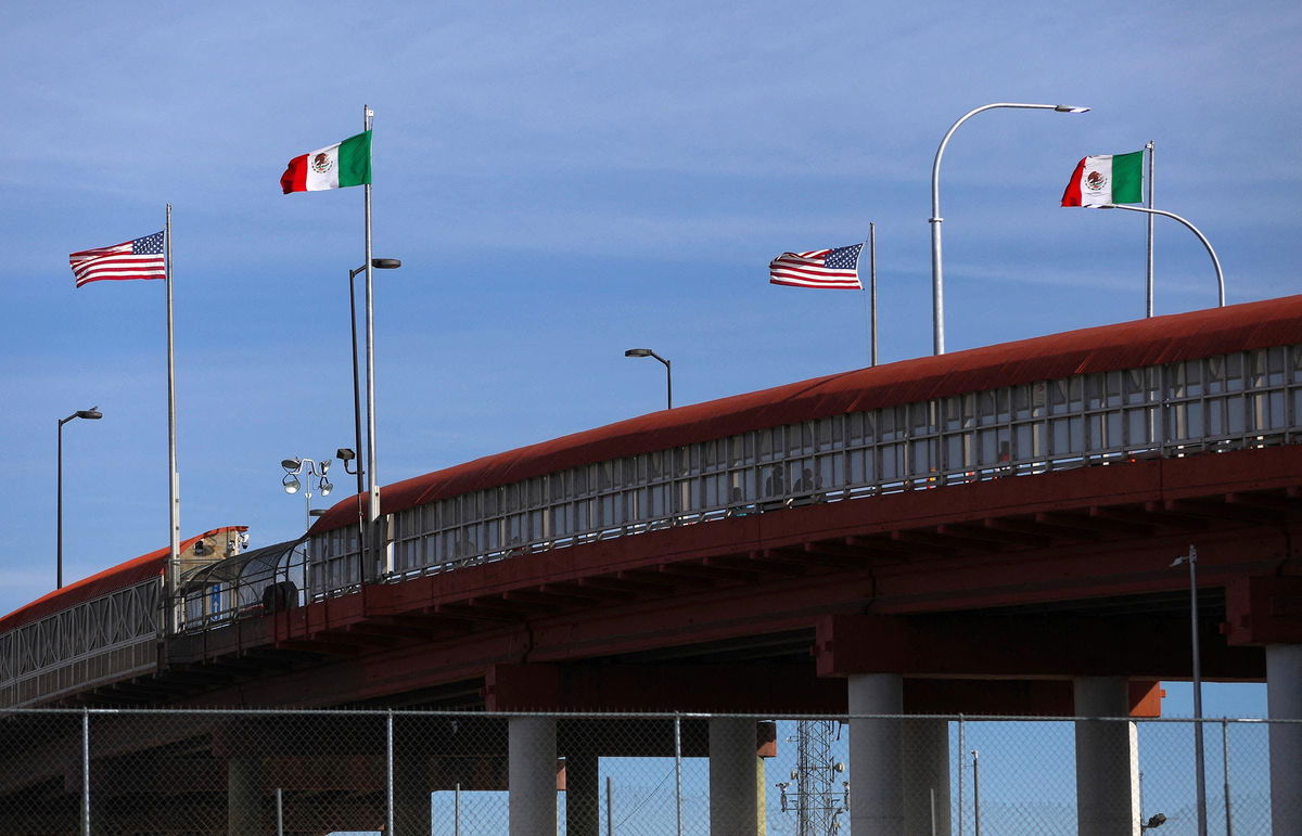 <i>Herika Martinez/AFP/Getty Images via CNN Newsource</i><br/>A bridge with Mexican and US flags is seen on the border of El Paso