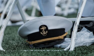 A US Navy hat is kept under a chair during the commissioning and graduation ceremony at the US Naval Academy in Annapolis