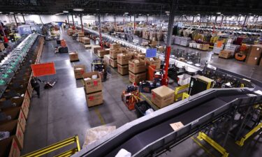 US Postal Service employees work inside the Los Angeles Mail Processing & Distribution Center on December 3. The facility is currently processing 1 million packages per day.