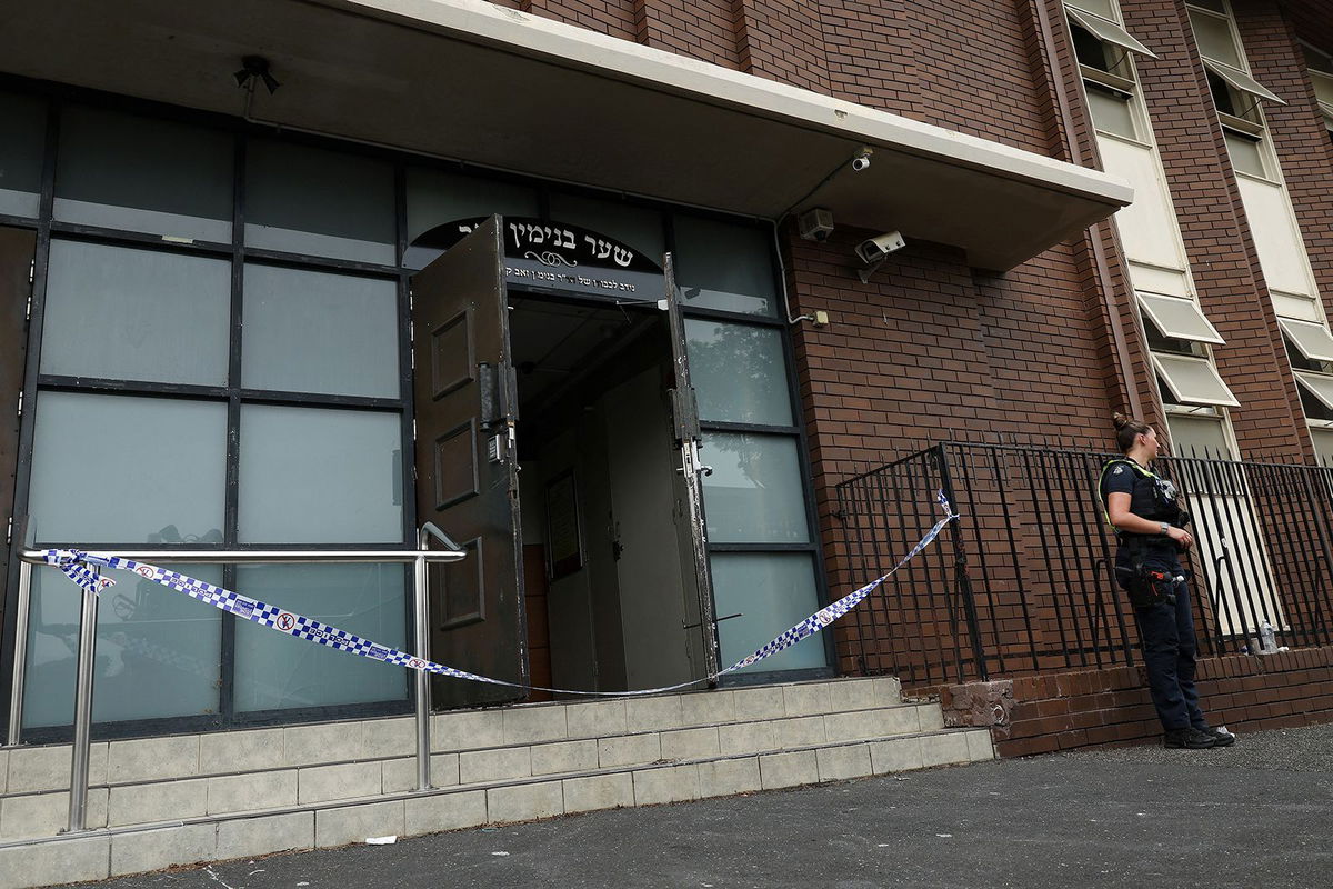 <i>AAP Image/Con Chronis via Reuters via CNN Newsource</i><br/>A policewoman stands guard at the scene of a fire at the Adass Israel Synagogue in Ripponlea