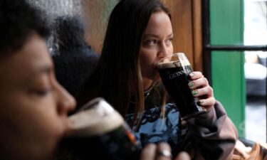 People drink Guinness beer at the Devonshire pub in London on October 10.