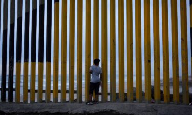 A boy looks through a border wall separating Mexico from the United States in November in Tijuana.