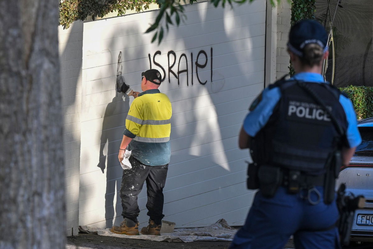 <i>Mick Tsikas/AAP Image/AP via CNN Newsource</i><br/>A contractor cleans anti Israel graffiti from a wall in the Sydney suburb of Woollahra