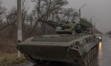 A Ukrainian serviceman operates a BMP-1 infantry fighting vehicle on a road near Pokrovsk