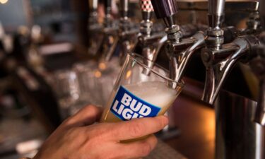 A bartender pours a Bud Light from a tap.