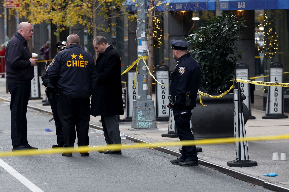 <i>Shannon Stapleton/Reuters via CNN Newsource</i><br/>Police officers stand near the scene where the CEO of United Healthcare