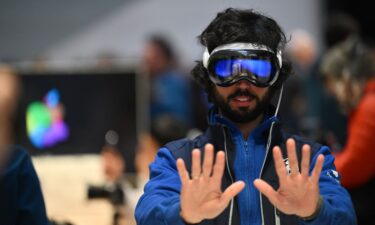 A customer tries on the Apple Vision Pro headset during the product launch at the Apple Store in New York City on February 2