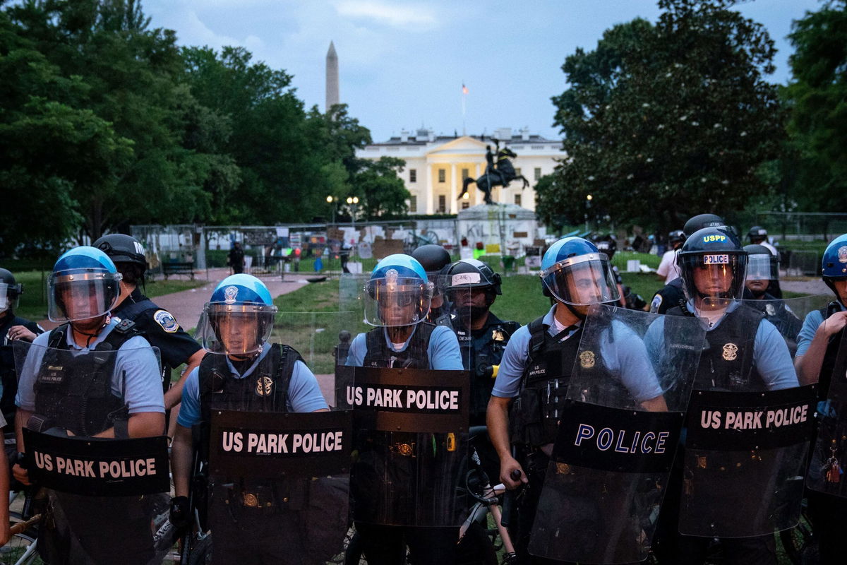 <i>Drew Angerer/Getty Images via CNN Newsource</i><br/>U.S. Park Police keep protesters back after they attempted to pull down the statue of Andrew Jackson in Lafayette Square near the White House on June 22 in Washington.