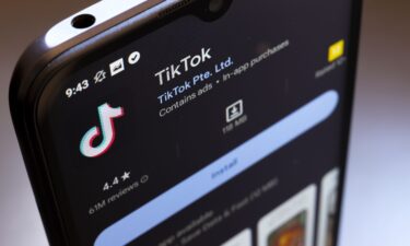 The TikTok logo appears on the screen of a smartphone in Reno