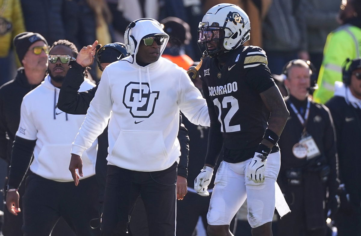 <i>David Zalubowski/AP/File via CNN Newsource</i><br/>Colorado head coach Deion Sanders speaks with Travis Hunter during a game in November.