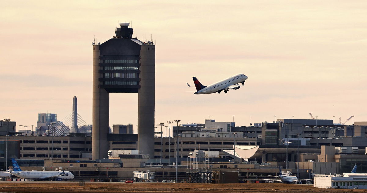 <i>Pat Greenhouse/The Boston Globe via Getty Images/FILE via CNN Newsource</i><br/>A Delta airplane takes off from Boston Logan International Airport in March 2023. Two men were arrested on December 14 on trespassing charges after a drone came “dangerously close” to Logan International Airport.