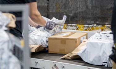 Workers fulfill orders at an Amazon fulfillment center on in Melville