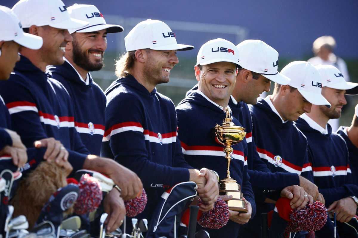 <i>Yara Nardi/Reuters via CNN Newsource</i><br/>Team USA captain Zach Johnson is pictured holding the trophy alongside Sam Burns and teammates during their team photo.