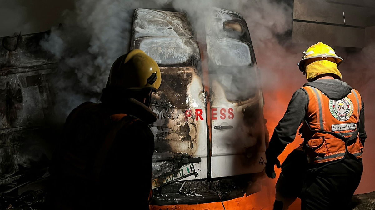 <i>Khamis Said/Reuters via CNN Newsource</i><br/>Civil Defense members put out a fire in a broadcast van following an Israeli strike that killed five journalists