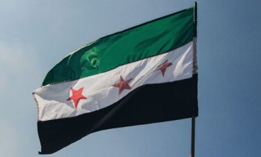 A Syrian opposition flag is waved in Damascus