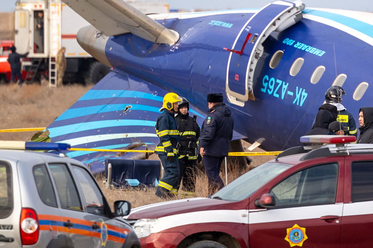 <i>Issa Tazhenbayev/AFP/Getty Images via CNN Newsource</i><br/>Emergency specialists work at the crash site in Aktau