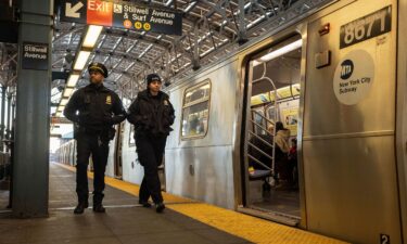 Police officers patrol the F train platform at the Coney Island-Stillwell Avenue Station in New York on December 26.