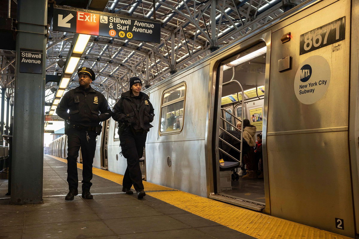 <i>Yuki Iwamura/AP via CNN Newsource</i><br/>Police officers patrol the F train platform at the Coney Island-Stillwell Avenue Station in New York on December 26.