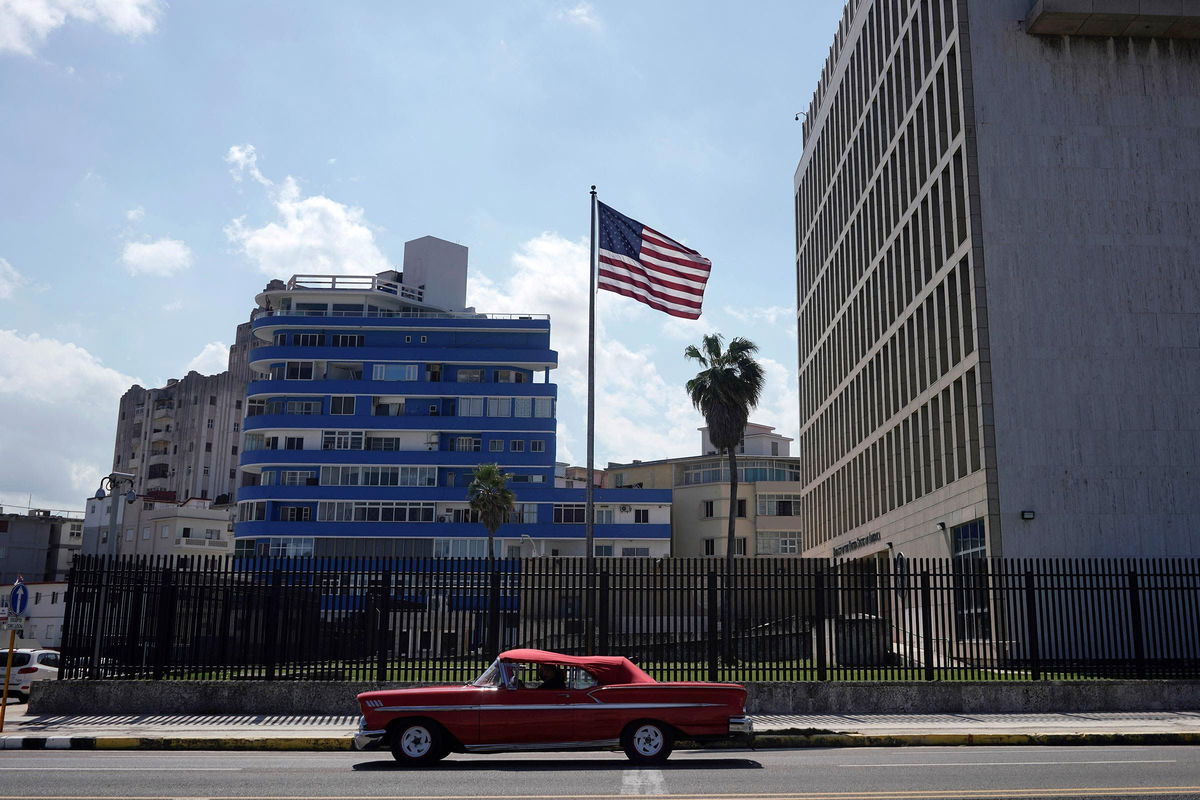 <i>Alexandre Meneghini/Reuters/File via CNN Newsource</i><br/>A vintage car used for city tours passes by the US Embassy in Havana