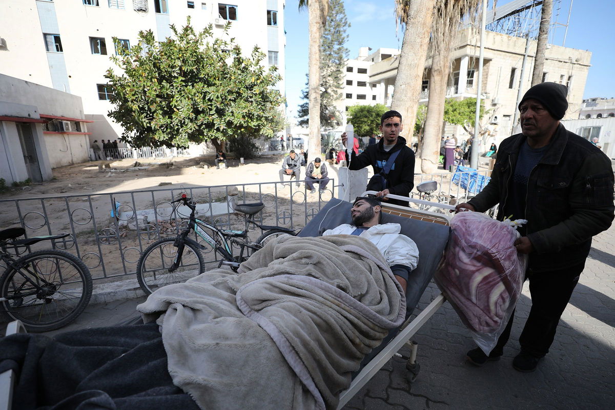 <i>Dawoud Abo Alkas/Anadolu/Getty Images via CNN Newsource</i><br/>Palestinian patients are transferred to al-Ahli Baptist Hospital after being evacuated from Kamal Adwan Hospital on December 28.