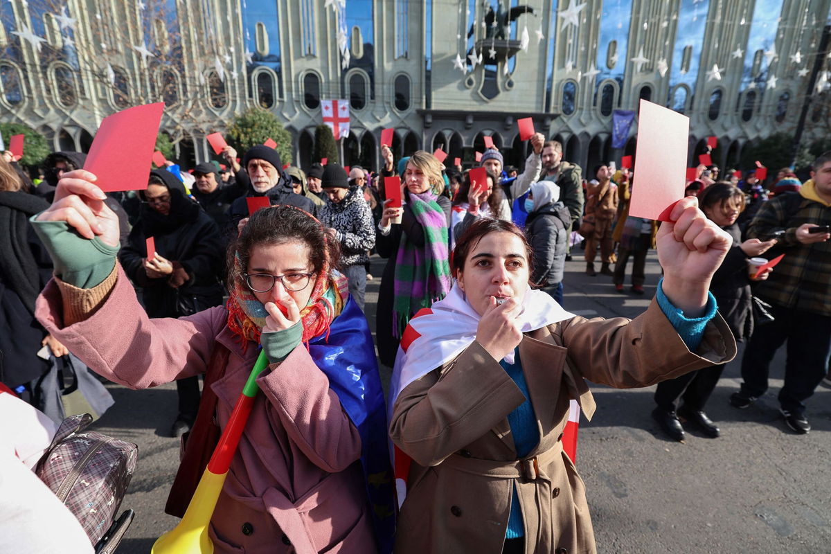 <i>Giorgi Arjevanidze/AFP/Getty Images via CNN Newsource</i><br/>Protesters rally ahead of the inauguration ceremony for Georgian President-elect Mikheil Kavelashvili