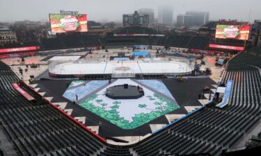 Workers transform Wrigley Field in Chicago into a hockey venue for the 2024 NHL Winter Classic matchup between the St. Louis Blues and the Chicago Blackhawks.