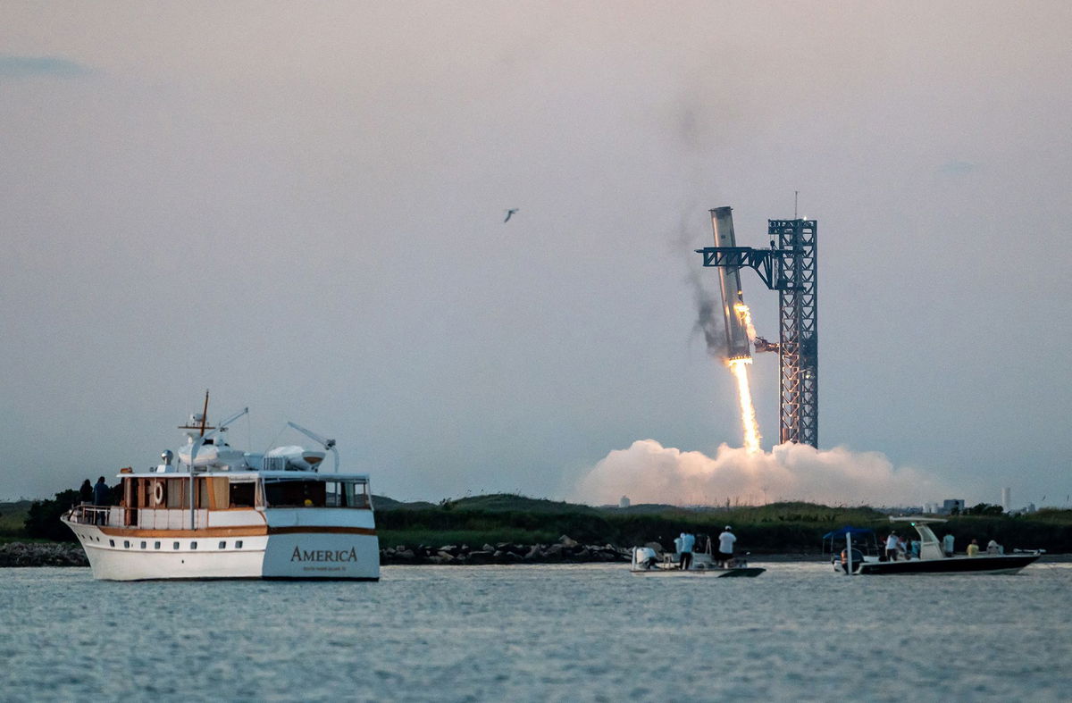 <i>Sergio Flores/AFP/Getty Images via CNN Newsource</i><br/>The Super Heavy rocket booster is caught midair at the SpaceX launchpad near Brownsville