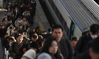 Commuters disembark from a train at a train station in Seoul on December 6.