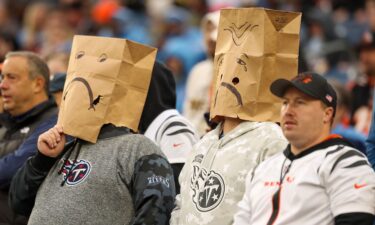 Tennessee Titans fans wear paper bags while watching their team play the Cincinnati Bengals. The Titans have been knocked out of playoff contention.