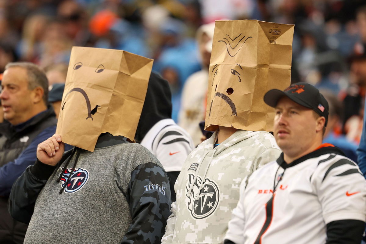 <i>Andy Lyons/Getty Images via CNN Newsource</i><br/>Tennessee Titans fans wear paper bags while watching their team play the Cincinnati Bengals. The Titans have been knocked out of playoff contention.