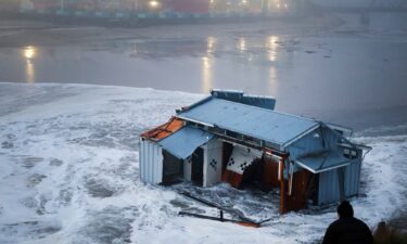 People look at a portion of the collapsed pier at the Santa Cruz Wharf in Santa Cruz