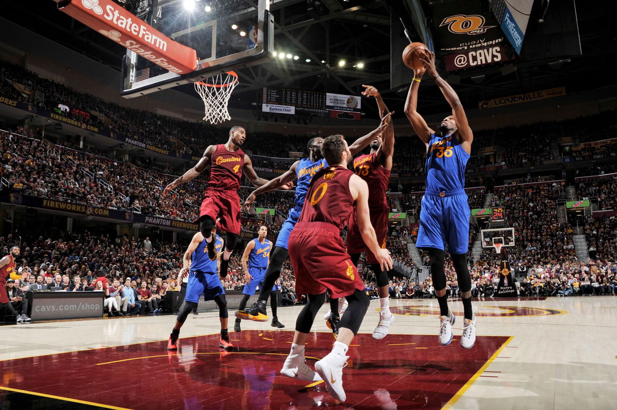 <i>David Liam Kyle/NBAE/Getty Images via CNN Newsource</i><br/>Kevin Durant shoots the ball in his first game as a Warrior against the defending champs.