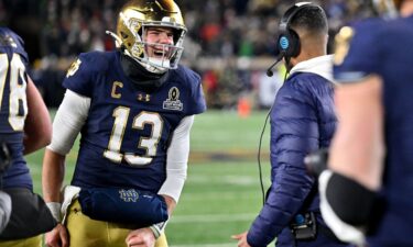 Notre Dame Fighting Irish quarterback Riley Leonard celebrates with head coach Marcus Freeman after scoring a touchdown during the second half against the Indiana Hoosiers at Notre Dame Stadium.