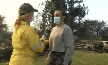 Kimiko Nickerson stands in front of what used to be her childhood home in Altadena