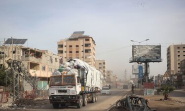 A truck carrying humanitarian aid drives on the main Salah al-Din road in the Nuseirat refugee camp in central Gaza on December 7