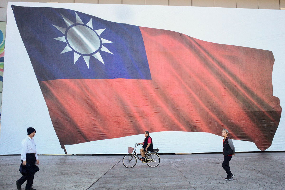 <i>Sam Yeh/AFP/Getty Images via CNN Newsource</i><br/>People walk past a Taiwanese flag in New Taipei City.