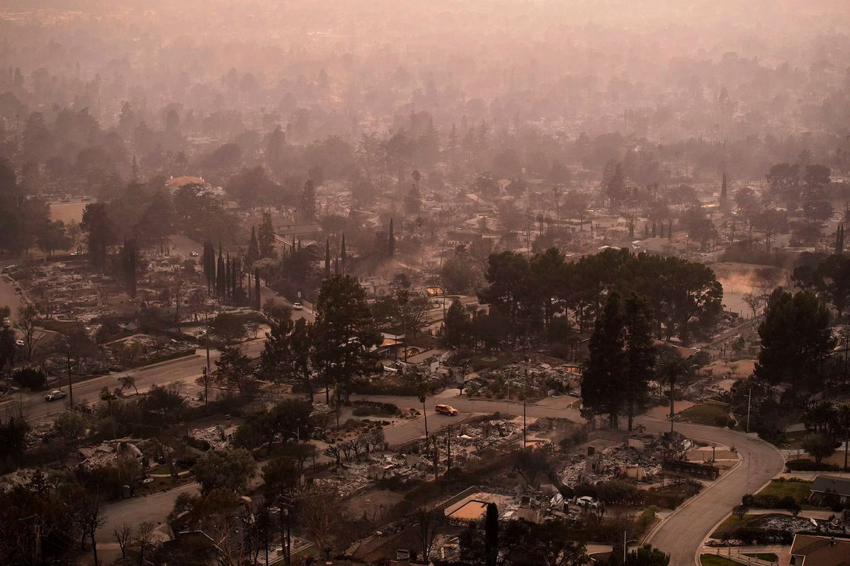 <i>John Locher/AP via CNN Newsource</i><br/>Smoke lingers over a neighborhood devastated by the Eaton Fire