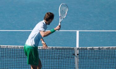 Daniil Medvedev takes aim at a small camera attached to the net after growing frustrated.