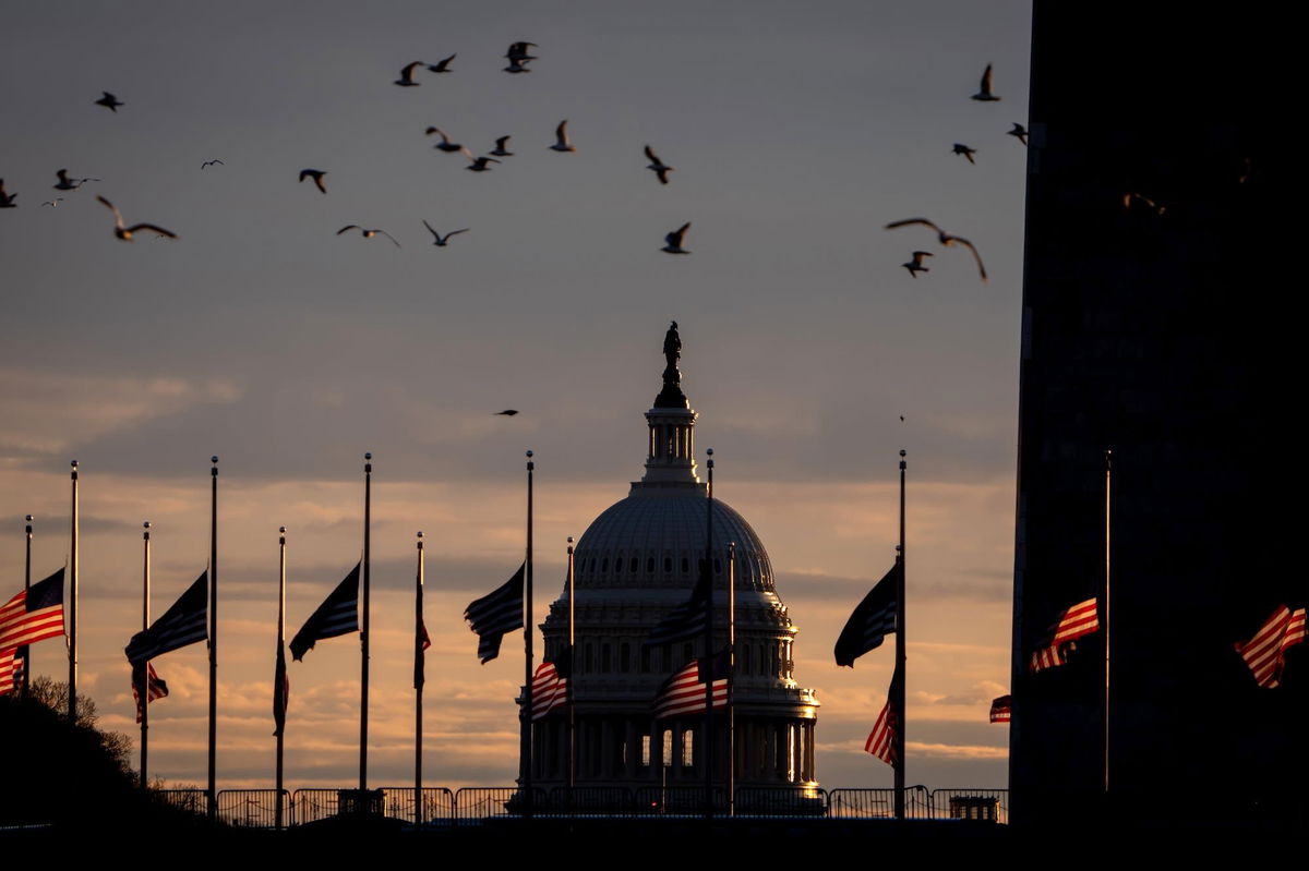 <i>Andrew Harnik/Getty Images via CNN Newsource</i><br/>The Dome of the U.S. Capitol Building is visible as flags are lowered to half-staff at the Washington Monument following the death of Jimmy Carter on December 30