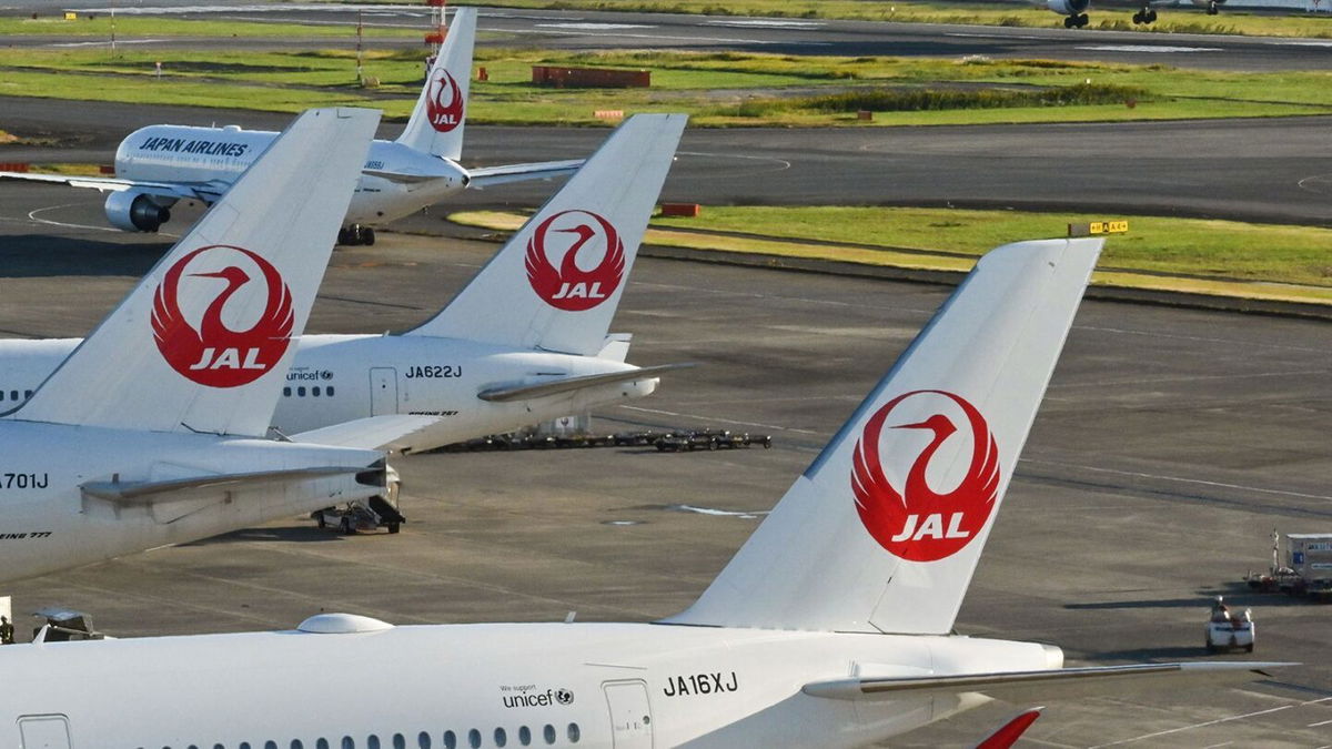 <i>Richard A. Brooks/AFP/Getty Images via CNN Newsource</i><br/>This photo taken on October 2022 shows passenger planes for Japan Airlines (JAL) on the tarmac as another (R) lands at Tokyo International Airport at Haneda in Tokyo.