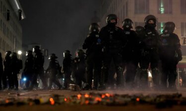 Police officers stand guard in the streets after fireworks celebrations in Berlin