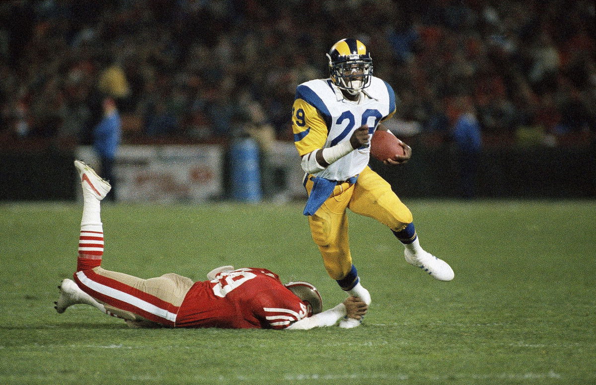 <i>Eric Risberg/AP/File via CNN Newsource</i><br/>Dickerson (right) broke the single-season rushing record in 1984.