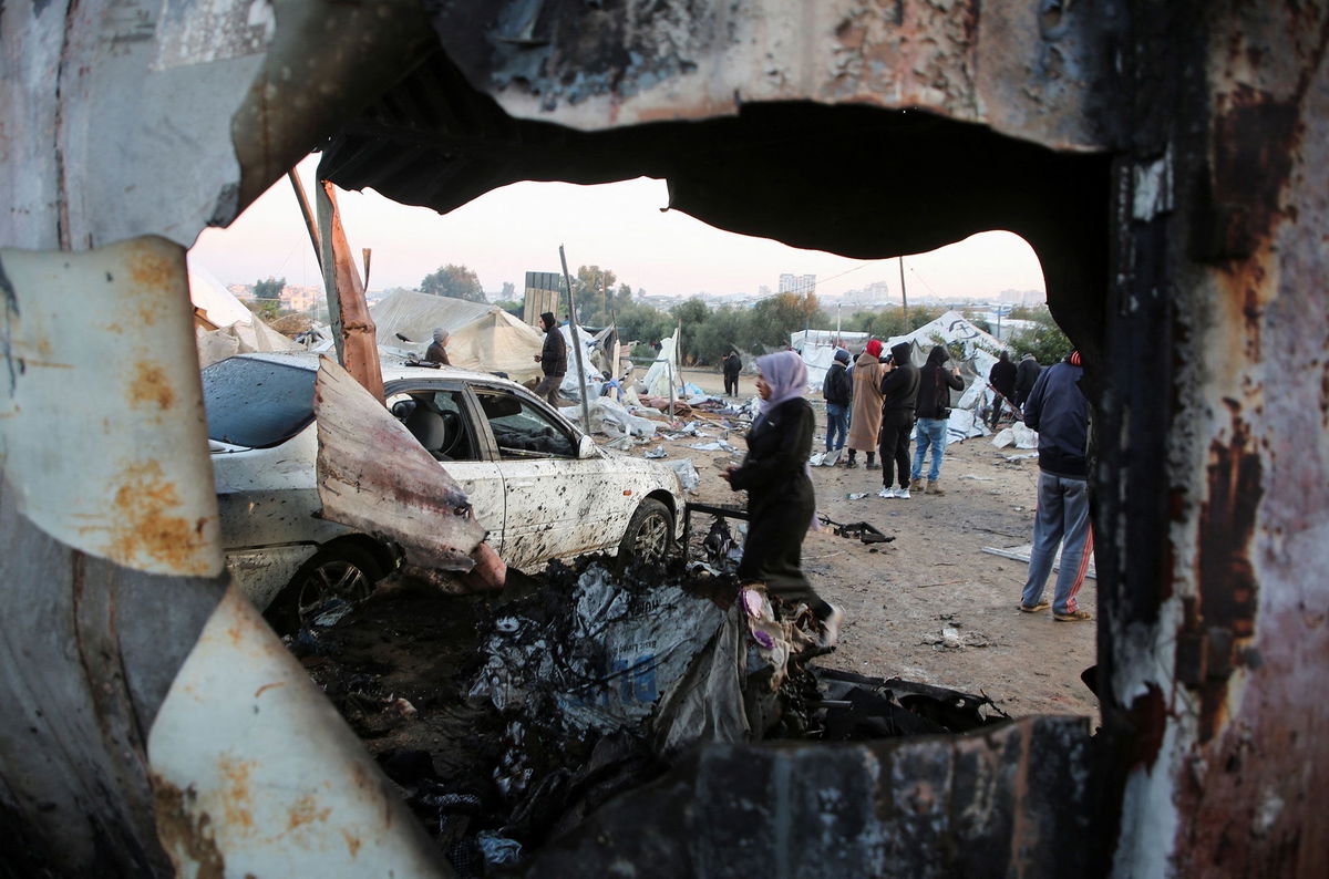 <i>Hatem Khaled/Reuters via CNN Newsource</i><br/>Palestinians survey the aftermath of an Israeli strike in Al-Mawasi