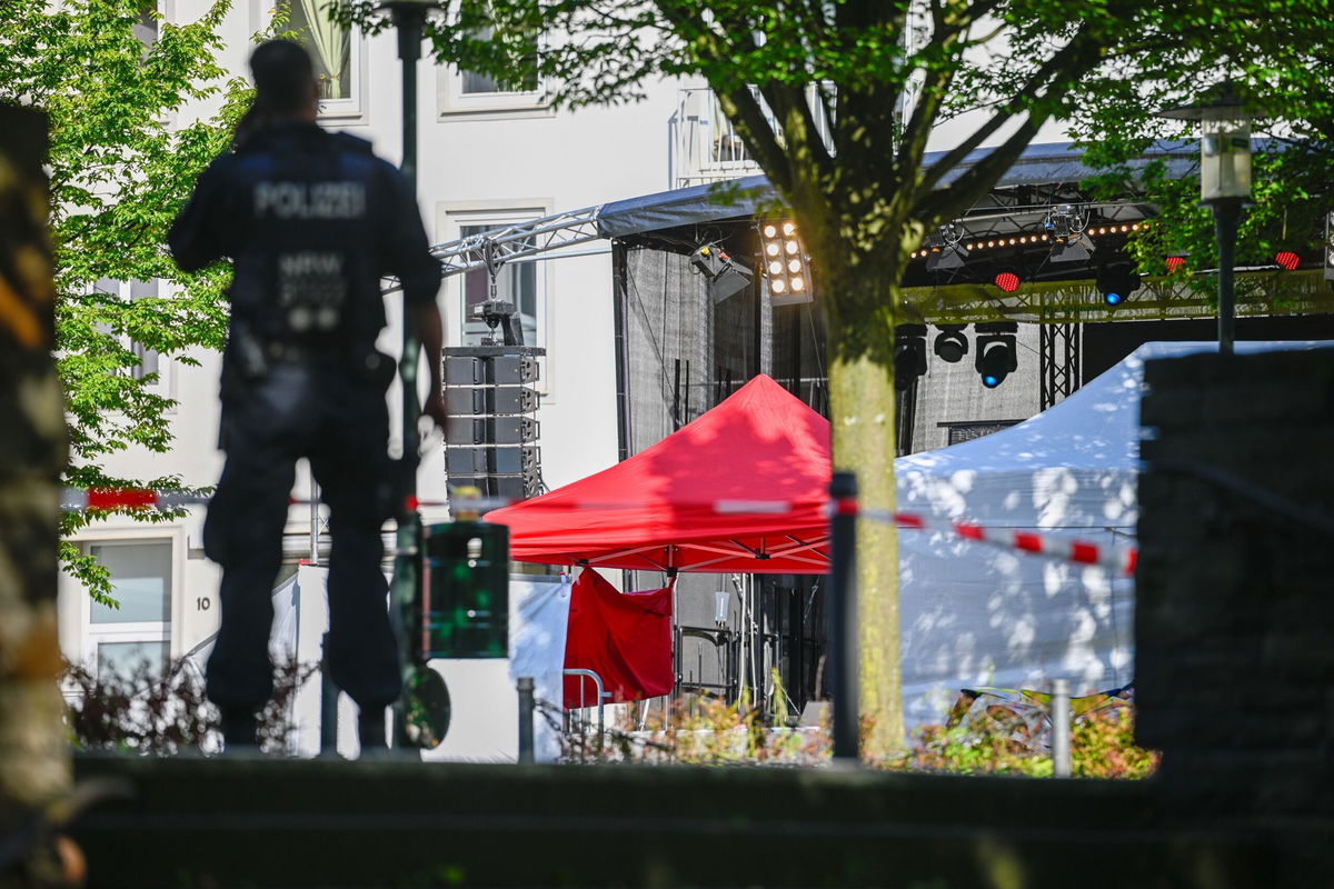 <i>Sascha Schuermann/Getty Images via CNN Newsource</i><br/>Police investigators stand at the site of yesterday's deadly stabbings that left three dead and eight injured in Solingen