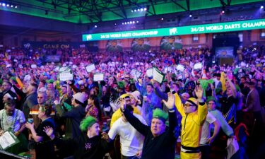 Darts fans create an almost pantomime atmosphere as the players compete.