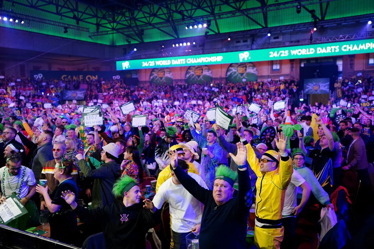 <i>Zac Goodwin/PA Images/Getty Images via CNN Newsource</i><br/>Darts fans create an almost pantomime atmosphere as the players compete.