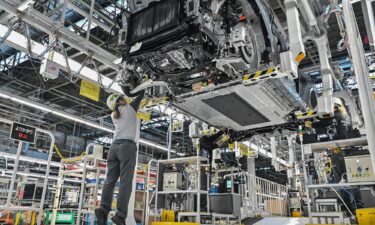 A worker checking a car on a Nissan production line.