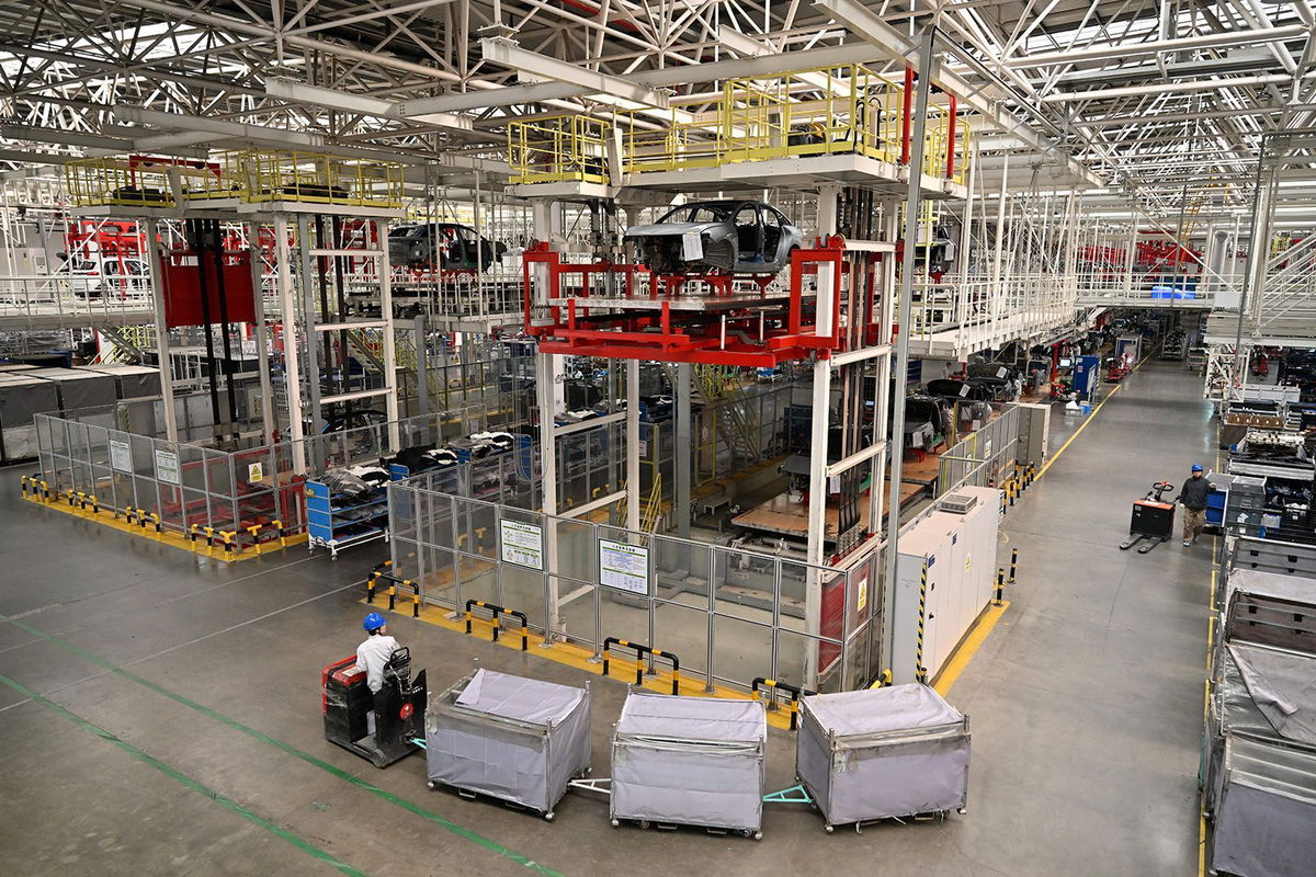 <i>Larry Leung/Feature China/Future Publishing/Getty Images via CNN Newsource</i><br/>A worker transports parts to the assembly line of electric cars at a Leap Motors plant in Jinhua in east China's Zhejiang province on November 26