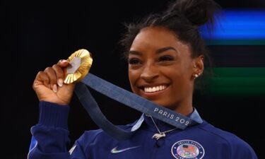 Simone Biles celebrates winning gold at the Paris Games in 2024.