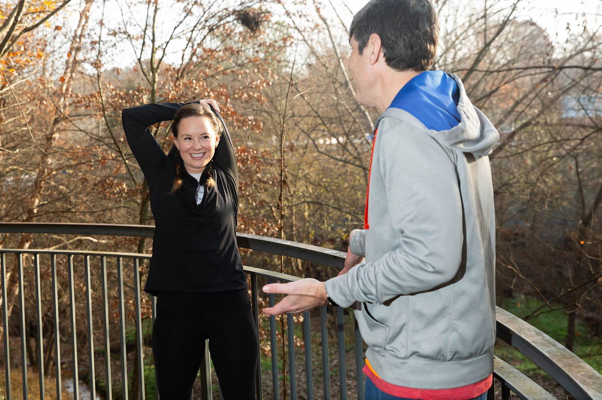 <i>Austin Steele/CNN via CNN Newsource</i><br/>Madeline Holcombe stretches while David Allan explains that when it comes to warming up he's not a great role model.